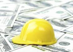 construction hat on money