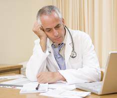 unhappy doctor looking at paperwork