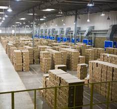 man on computer in warehouse