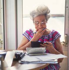 elderly woman balancing checkbook